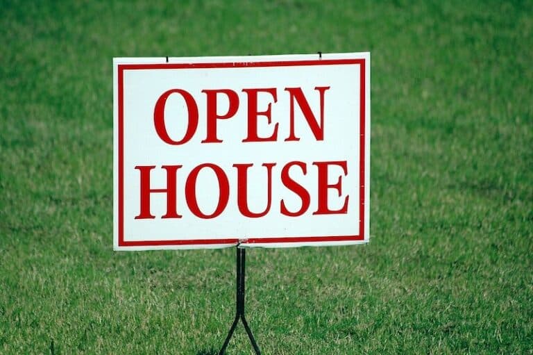 red and white open house sign on lawn