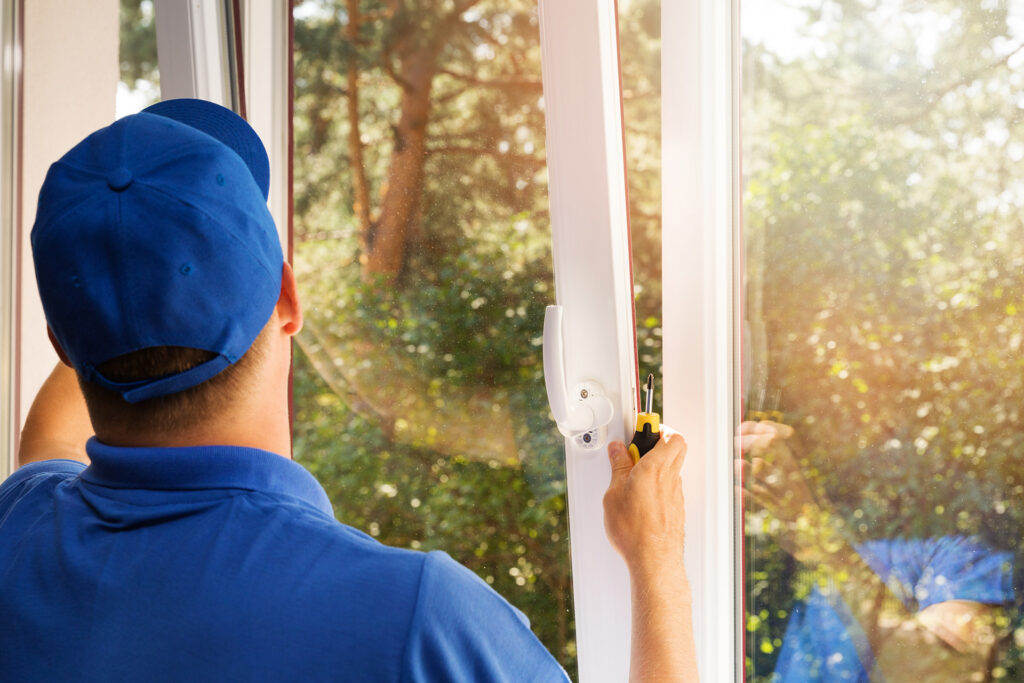 worker installing new plastic pvc window